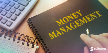 Man looking through his money management book with calculator on the side