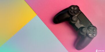 Video game controller on a yellow, blue and pink background