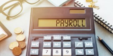 Payroll written on a calculator