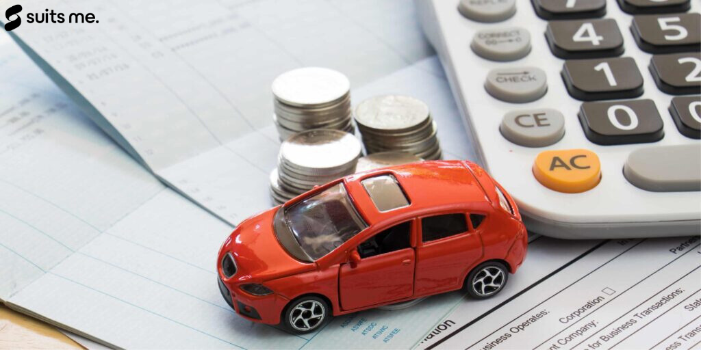 missed car payment concept. Toy car, money, calculator on top of financial documents.